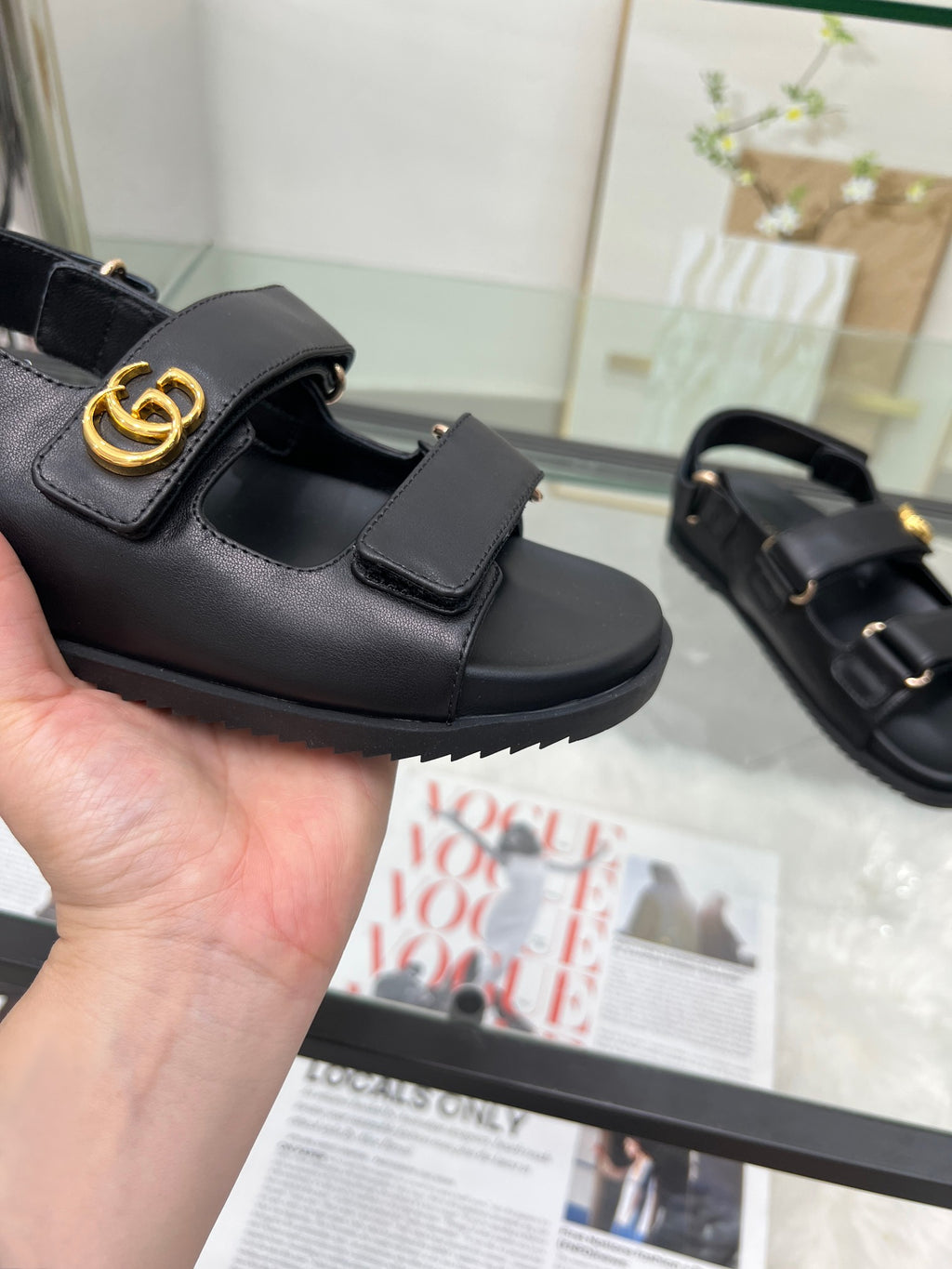 Gucci black sandal with gold logo on strap and adjustable buckle