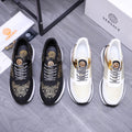 Versace sneakers in black and white with patterned laces and gold emblem detailing