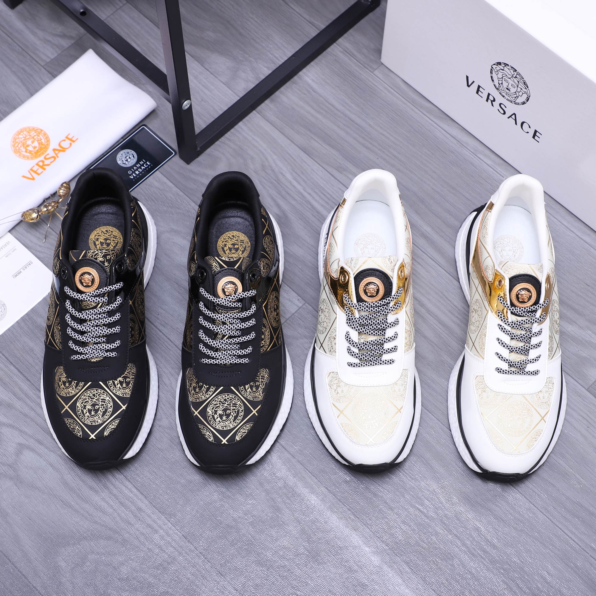 Versace sneakers in black and white with patterned laces and gold emblem detailing