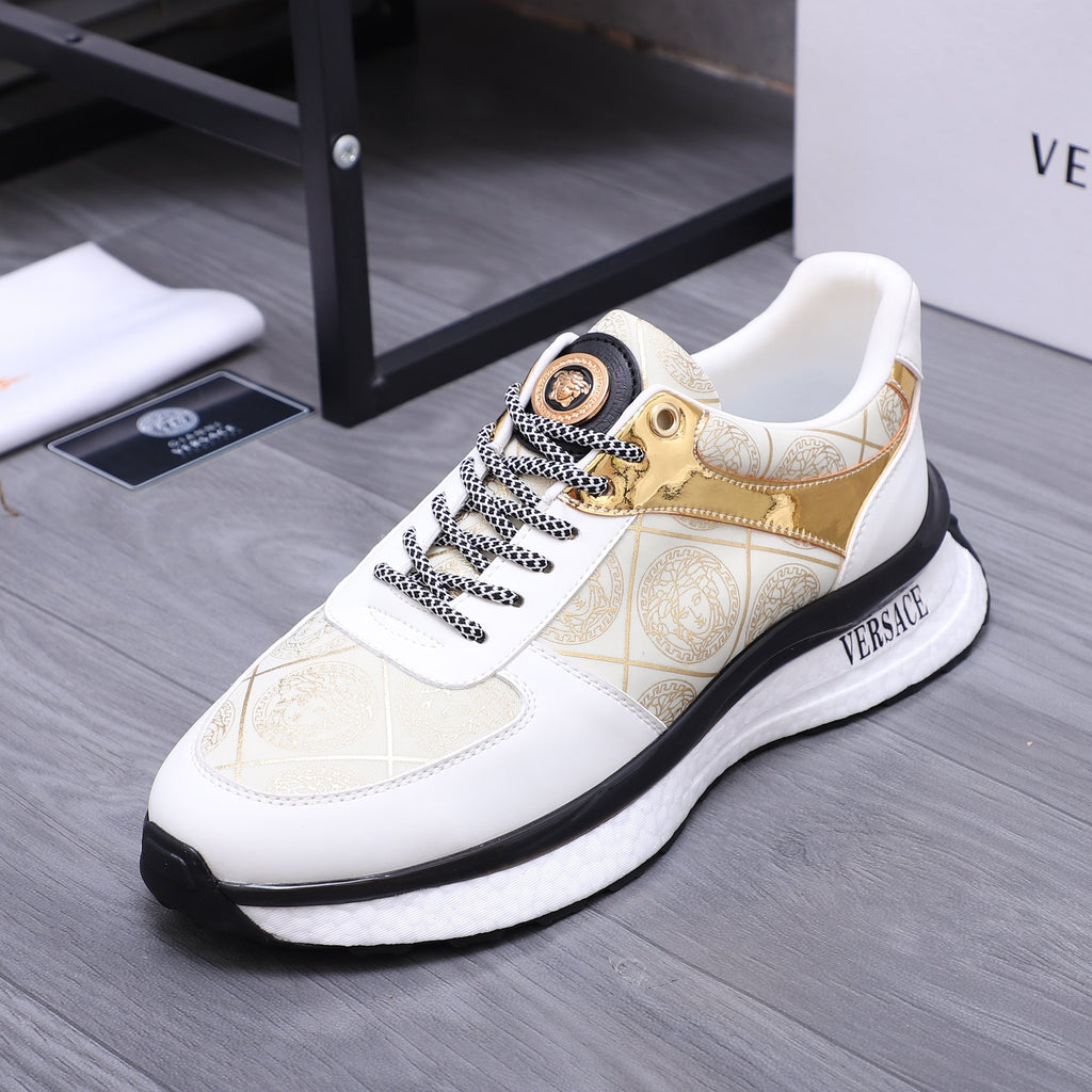 Versace white sneakers with gold patterned upper, braided laces, and textured black sole