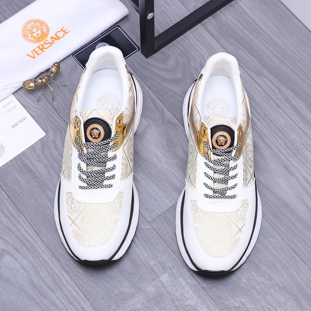 Versace white sneakers with gold patterned panels, lace trim, and black sole edge