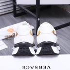 Versace sneakers with white back view and dark tread soles, showing heel profile
