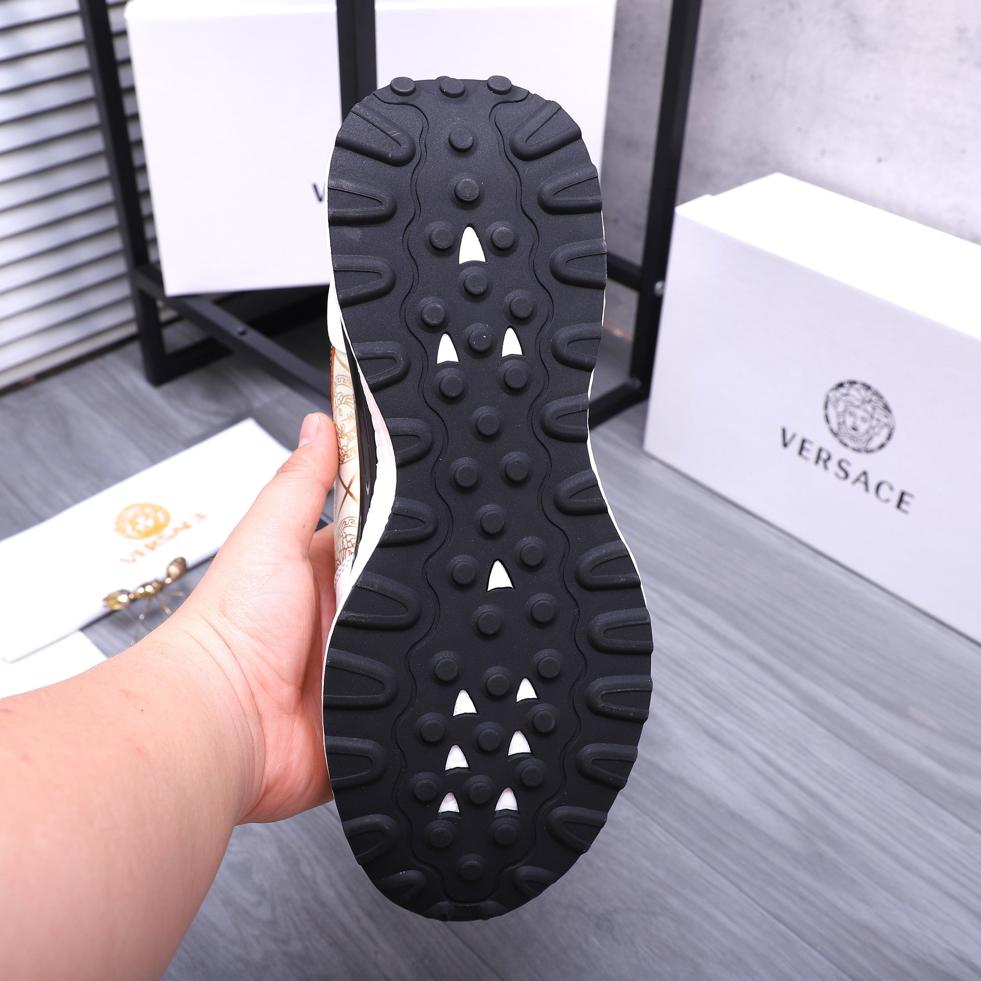 Versace sneaker outsole view with raised rubber nubs and traction tread pattern