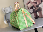 Louis Vuitton green checkered mini duffel bag with tan shoulder strap and gold hardware