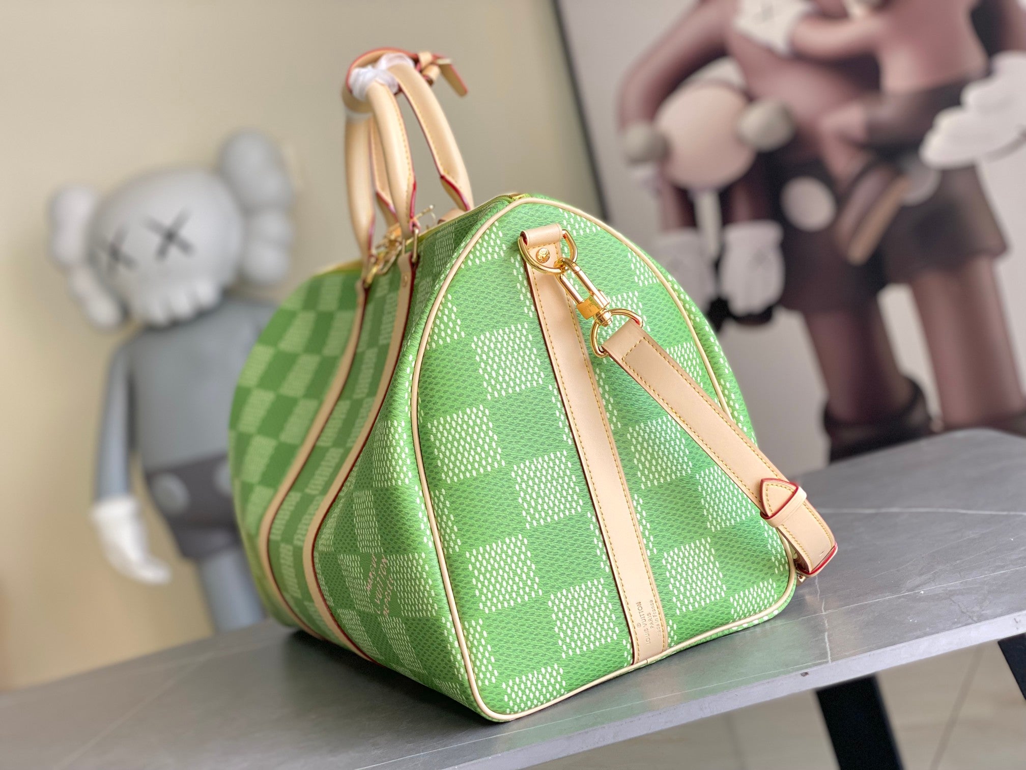 Louis Vuitton green checkered mini duffel bag with tan shoulder strap and gold hardware