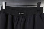 Balenciaga waistband close-up with logo, dark pleated fabric