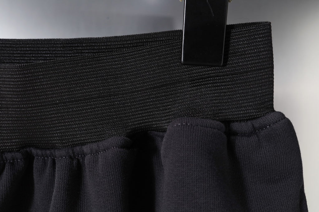 Balenciaga side seam and hem detail on dark shorts