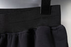 Balenciaga side seam and hem detail on dark shorts