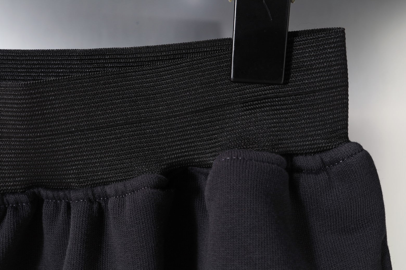 Balenciaga side seam and hem detail on dark shorts