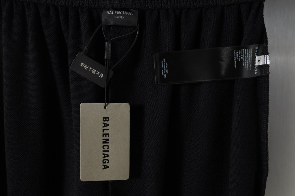Black pants with elastic waistband and attached Balenciaga hang tag