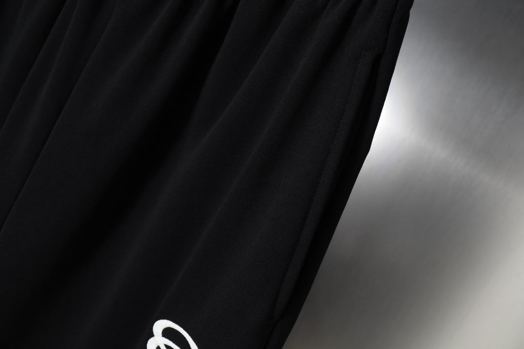 Black fabric with smooth drape and fine stitched texture