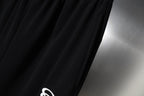 Black fabric with smooth drape and fine stitched texture