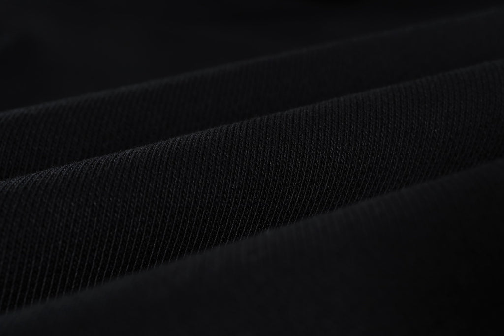 Black woven fabric close-up with subtle fine texture