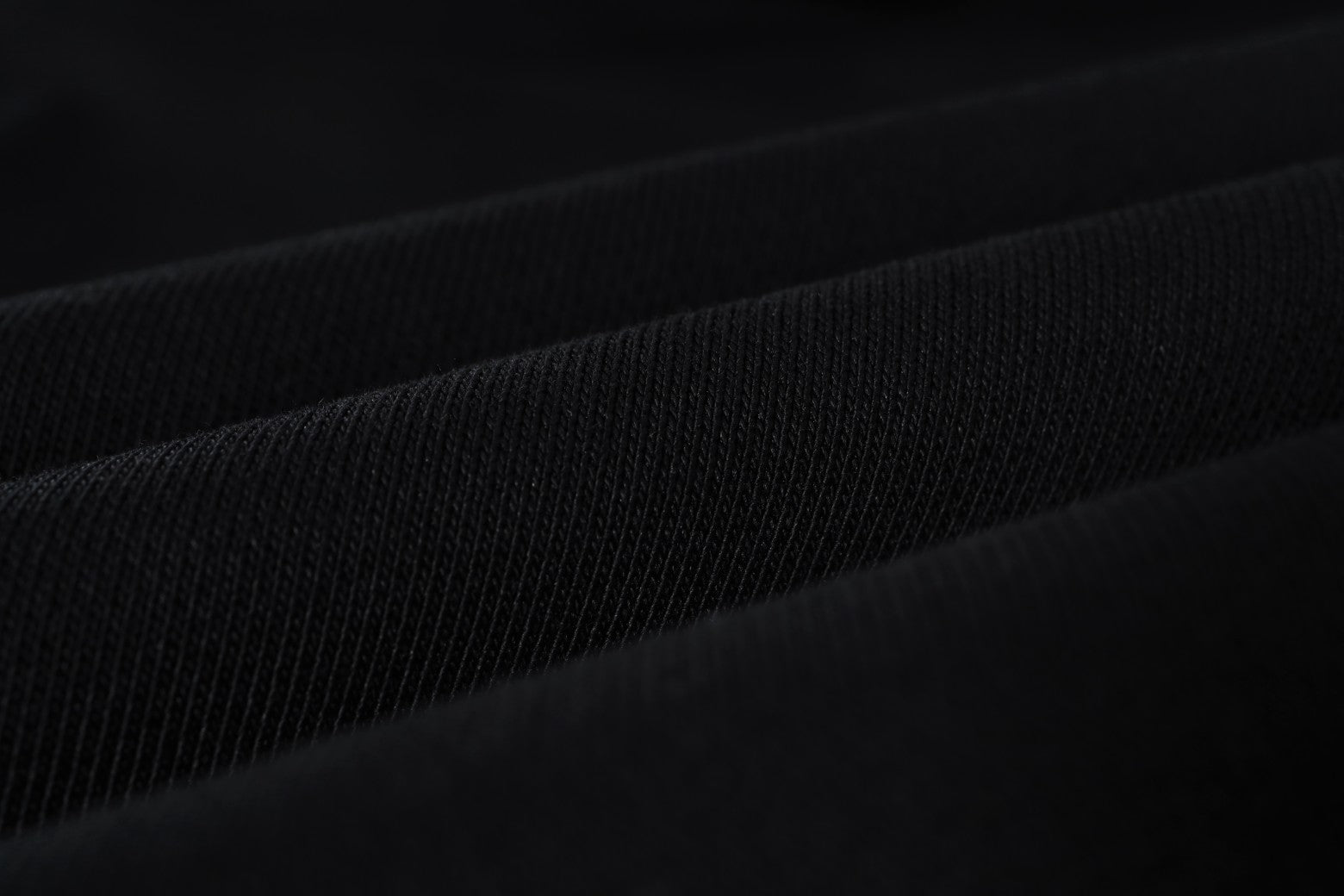 Black woven fabric close-up with subtle fine texture