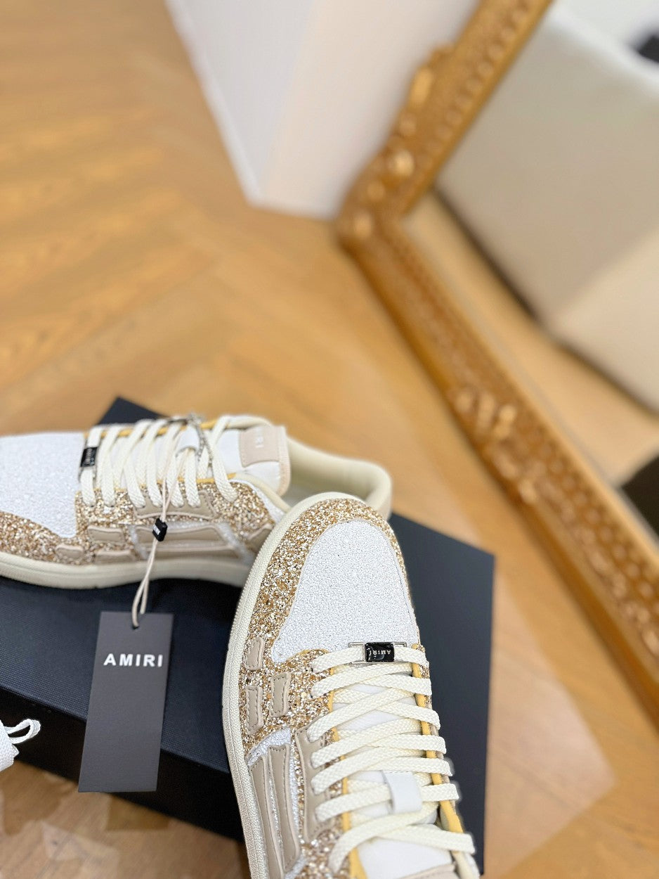 Amiri sneakers close-up: white and gold glitter upper with white lace-up front