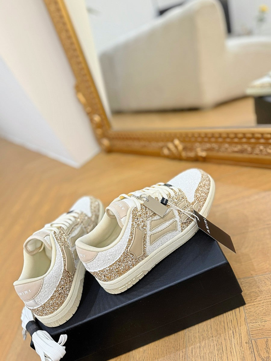 Amiri low-top sneakers with white uppers and gold glitter quarter panels, rubber sole