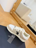 Amiri low-top sneakers with white leather, gold glitter side stripe, lace-up design