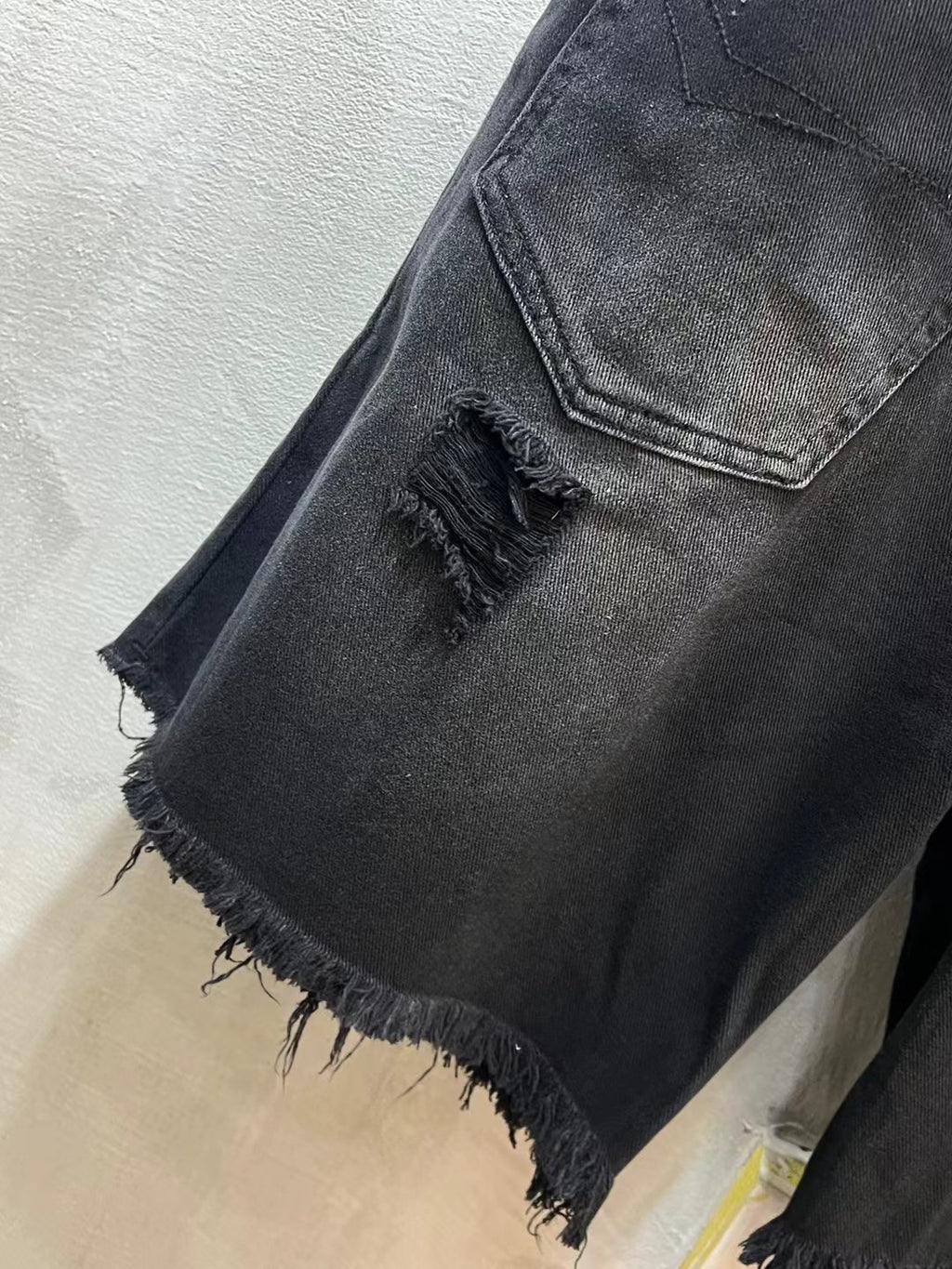 Balenciaga denim shorts, dark blue, distressed leg opening, frayed hem, pocket flap