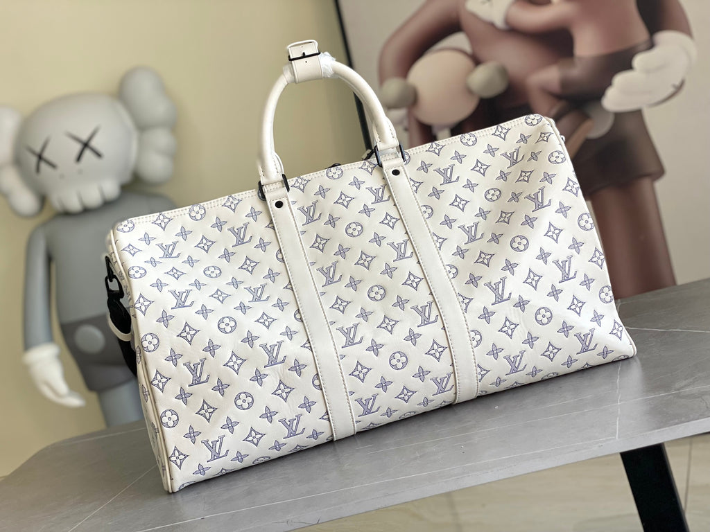 Louis Vuitton monogram duffel bag with white leather trim and top handles