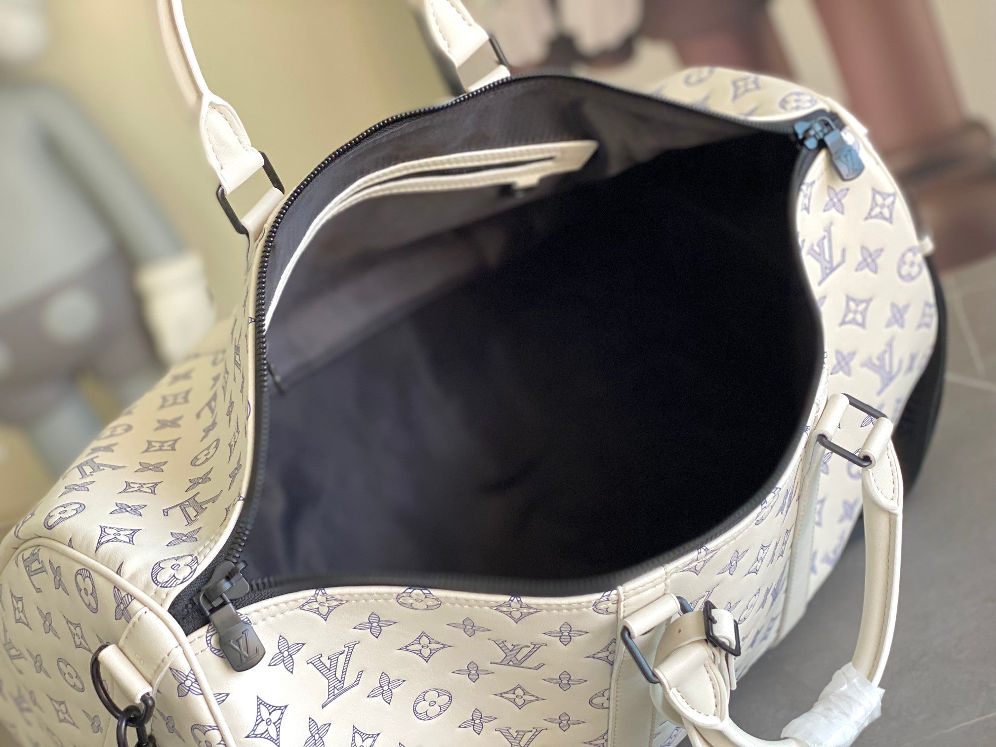 Louis Vuitton monogram duffel bag interior with dark lining and zipper edge