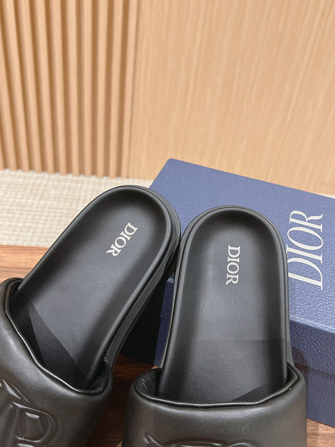 Black Dior slide sandals, white Dior text on footbed interior