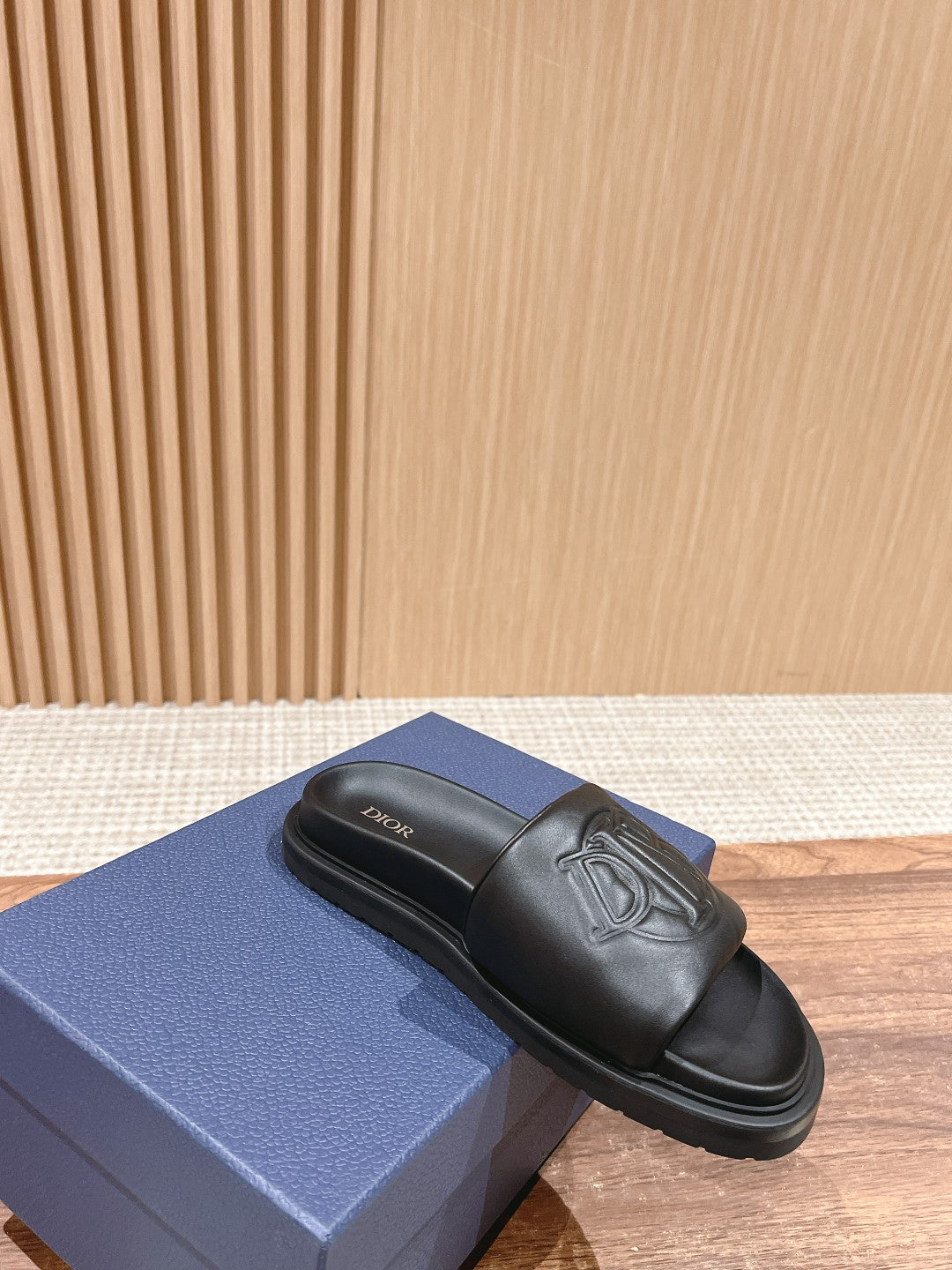 Black Dior unisex slide sandals with embossed logo on one strap