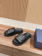 Black Dior unisex slide sandals with embossed Dior logo and molded footbed