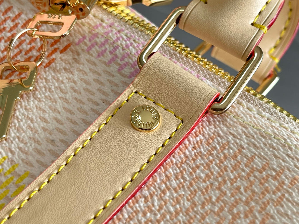 Louis Vuitton strap hardware on cream leather with gold-tone buckle and stitching