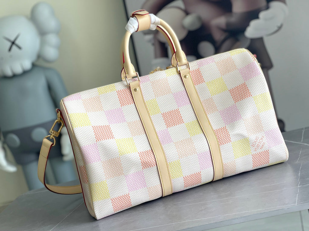 Louis Vuitton duffel-style bag with multicolor check canvas and cream leather straps