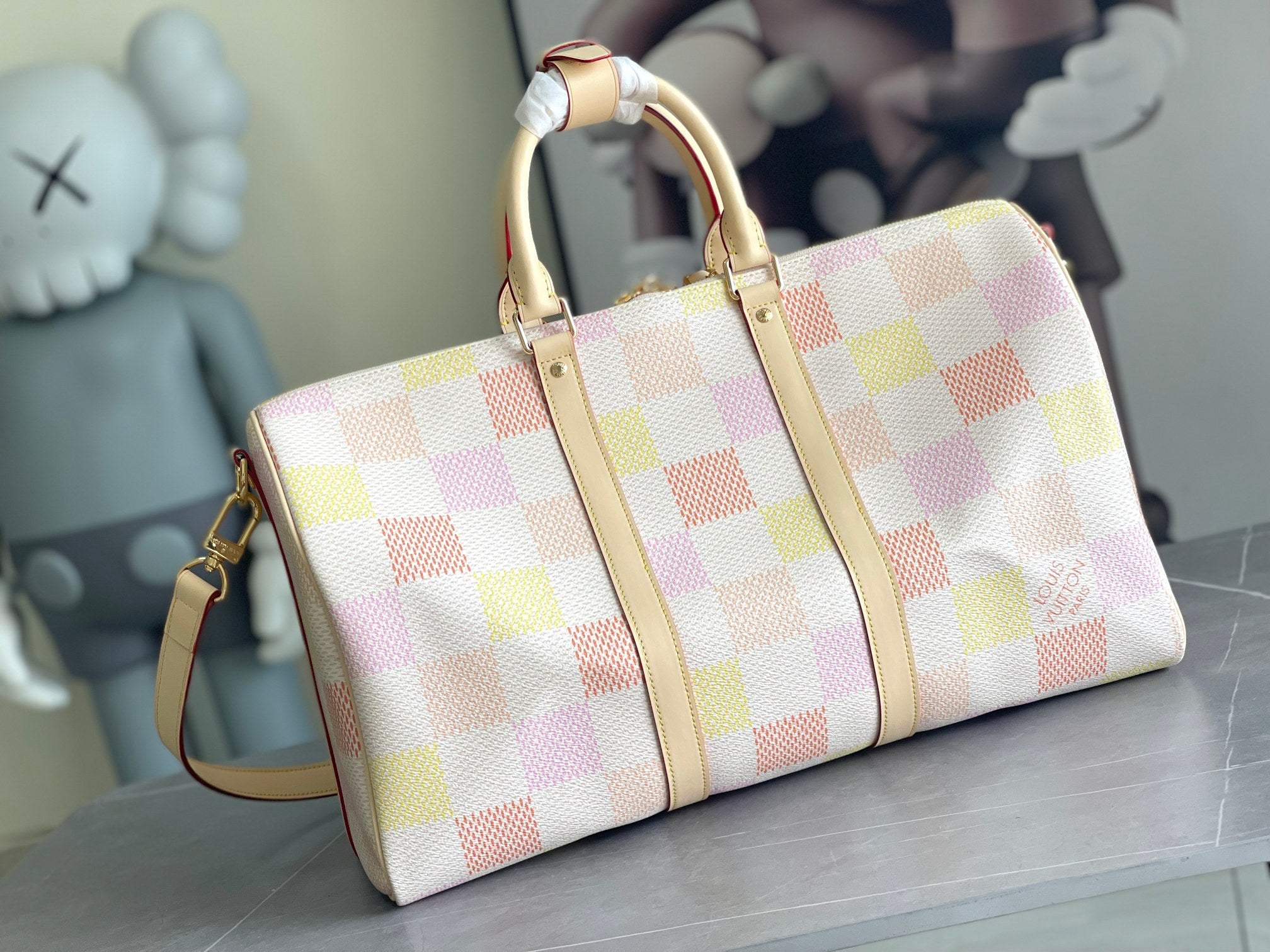 Louis Vuitton duffel-style bag with multicolor check canvas and cream leather straps