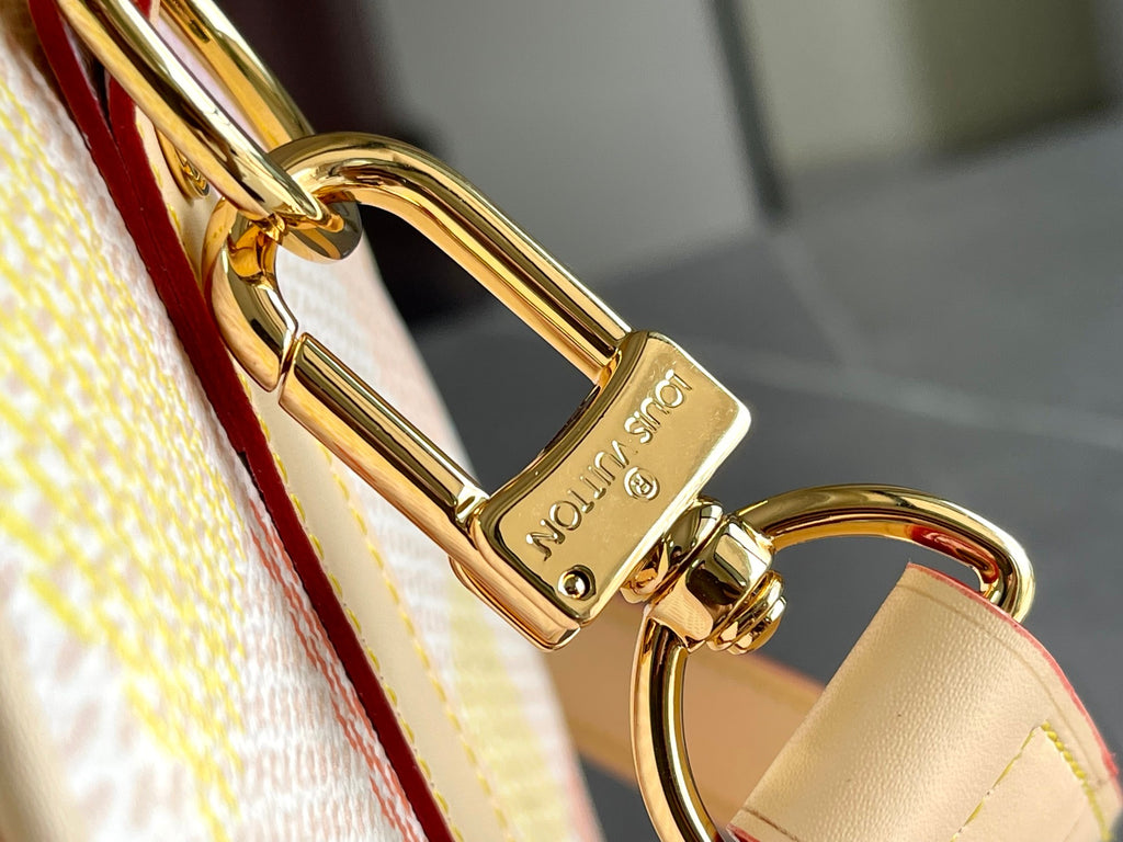Louis Vuitton gold-tone clasp with leather strap loop and red edge detail