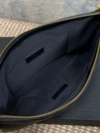 Small quilted bag interior view with fabric lining and two slot pockets