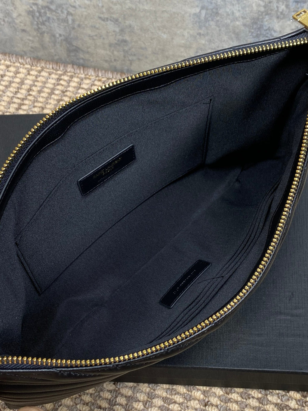 Black fabric lining with slip pockets inside YSL bag