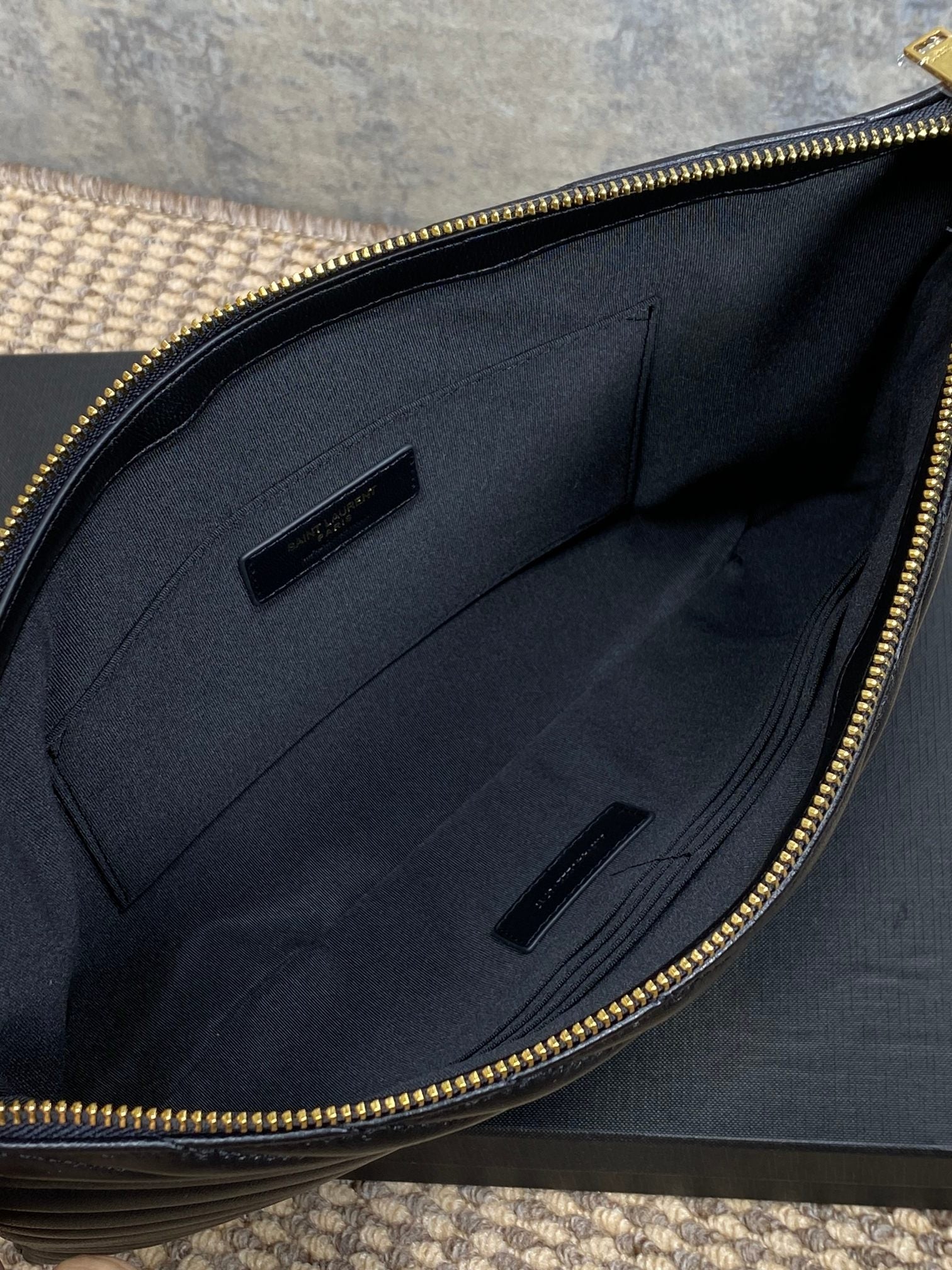 Black fabric lining with slip pockets inside YSL bag