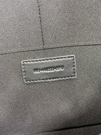Close-up of interior label on small quilted bag, Saint Laurent Paris text