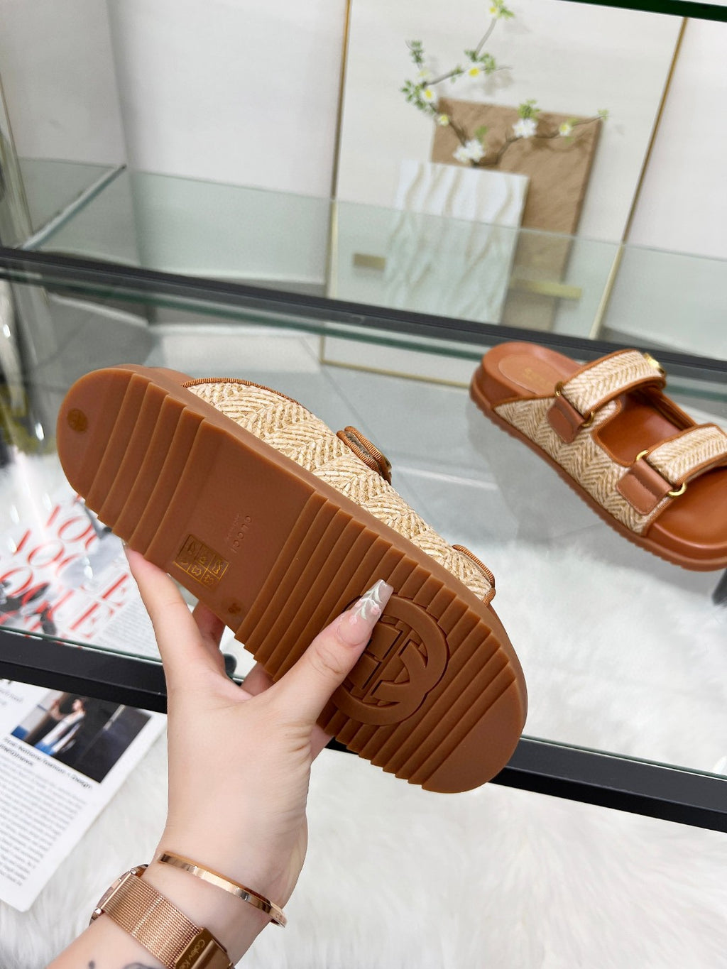 Gucci slide sandals outsole with tan textured strap and brown rubber sole tread