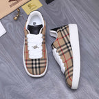 Burberry low-top sneakers set with plaid upper, white laces, and white side panels