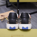Burberry sneakers from the back with tan plaid sides and blue traction heel detail