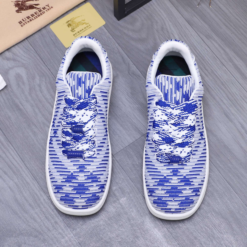 Blue and white knit lace-up sneakers, front view with white soles