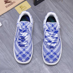 Blue and white knit lace-up sneakers, front view with white soles