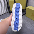 Bottom view of blue outsole on white knit lace-up sneaker