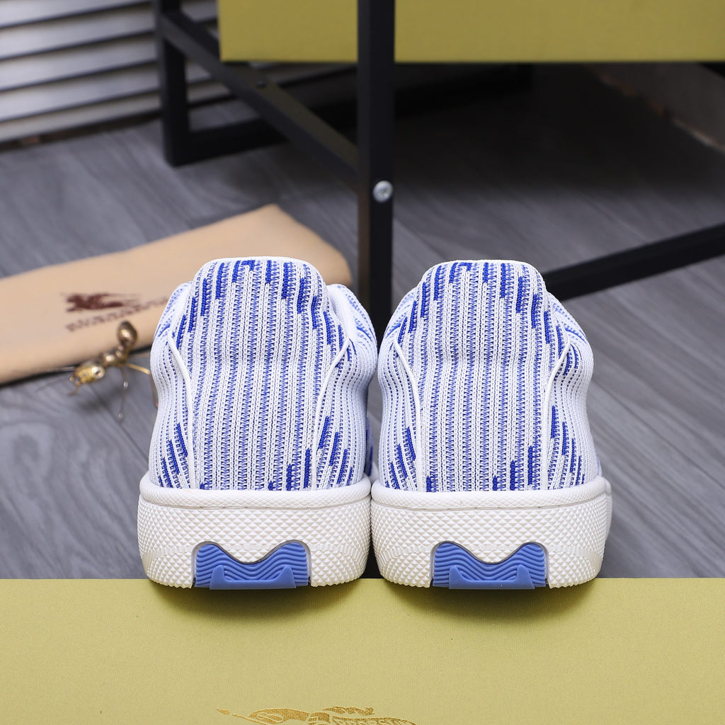 Back view of blue and white knit lace-up sneakers with blue heel accents