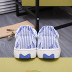 Back view of blue and white knit lace-up sneakers with blue heel accents