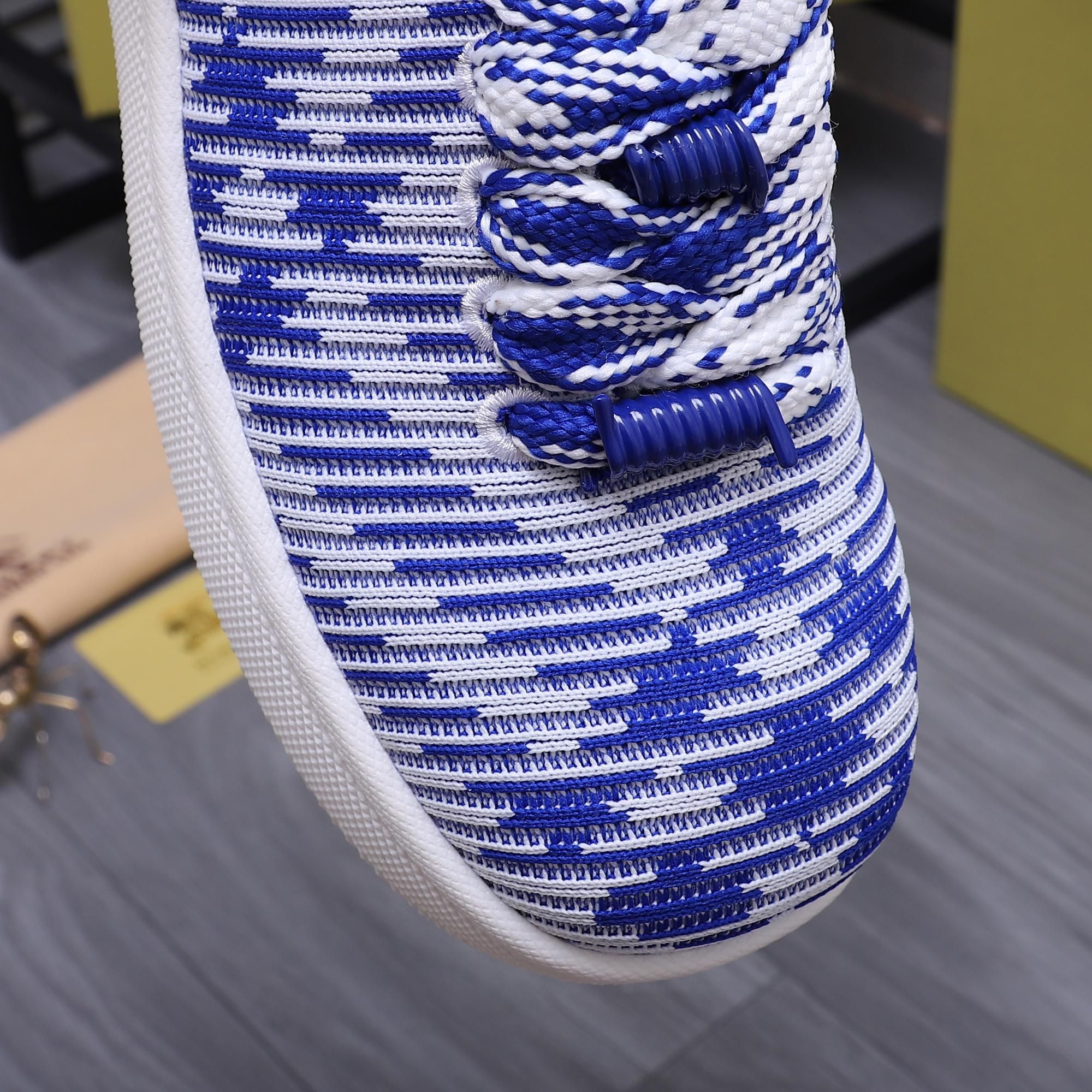 Close-up of blue and white knit lace-up sneaker upper and laces