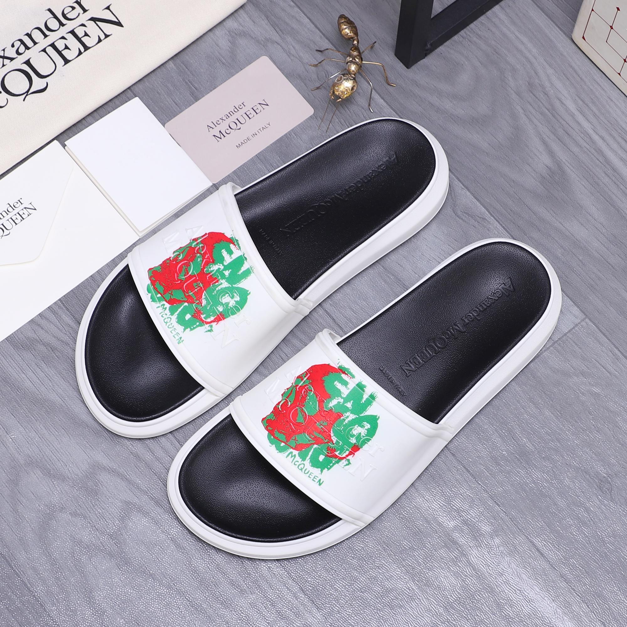 Slide sandals set: black footbeds with white straps and red-green graphic art.