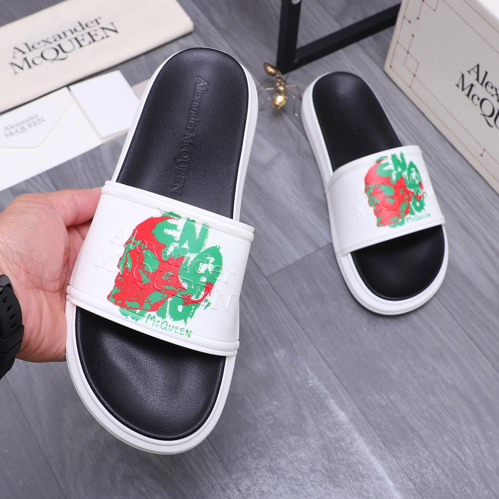 Leather slide sandal with white strap and red/green graphic print, black footbed.