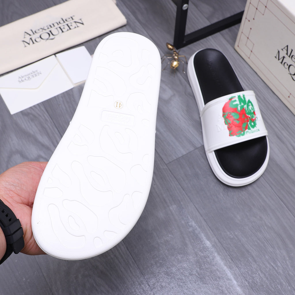 Slide sandal outsole, white rubber sole with embossed pattern, paired with black foot.