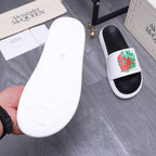 Slide sandal outsole, white rubber sole with embossed pattern, paired with black foot.