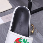 Slide sandal interior with faint branding, black insole and white edge.