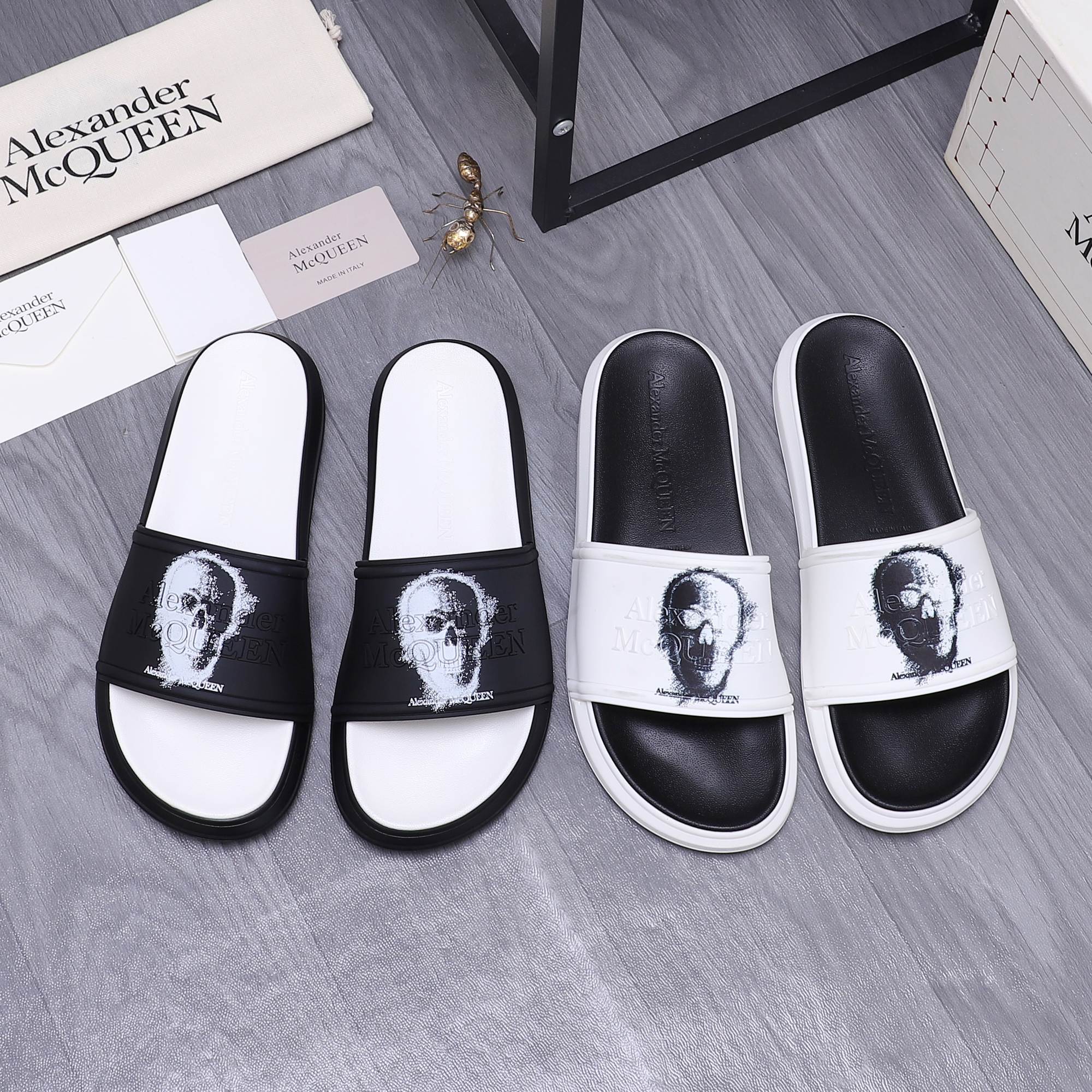Alexander McQueen slide sandals, black strap with white portrait print, white footbed.